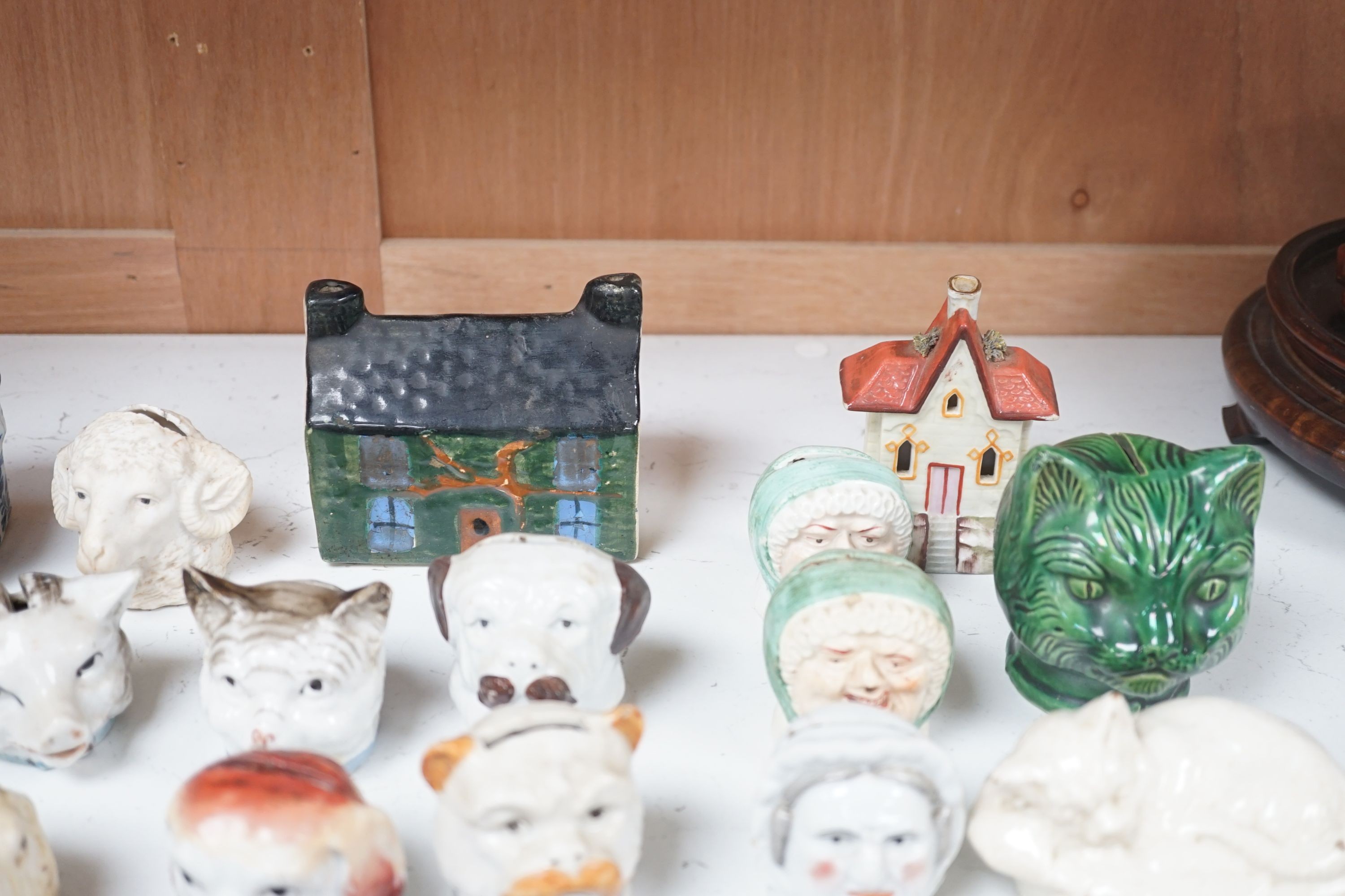 A 19th century Mauchline ware money box, together with fifteen other 19th century ceramic money boxes, Mauchline money box 8.5 cms high.